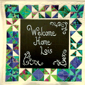 This quilted pinwheel wall hanging greets Lois at her new home.