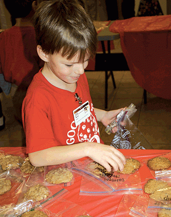 First grader Ethan Wood tries to decide which goodies to purchase. This year, 4,616 cookies were sold.