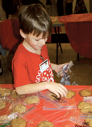 First grader Ethan Wood tries to decide which goodies to purchase. This year, 4,616 cookies were sold.